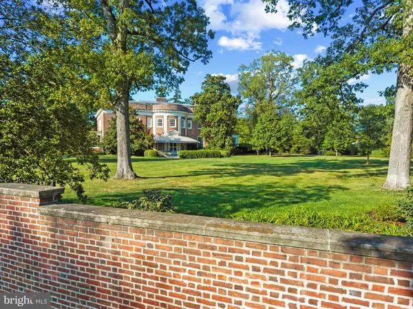 a dining room with furniture a chandelier and wooden floor