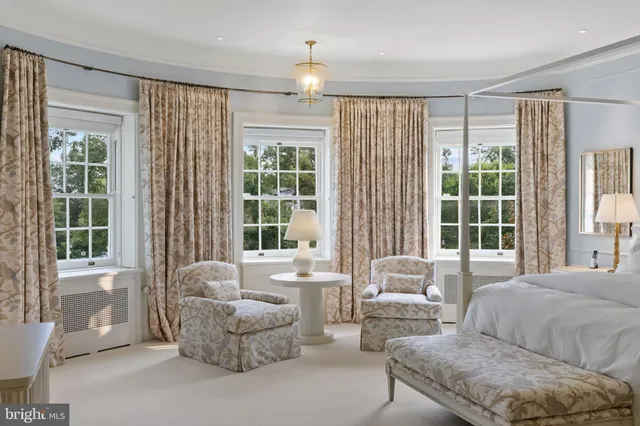 a living room with furniture and a lamp