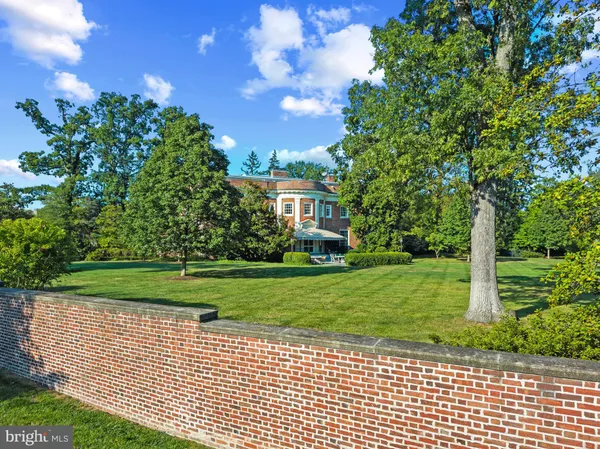 a living room with patio furniture and a chandelier