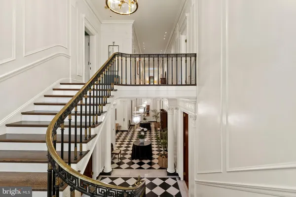 a view of a hallway with wooden floor and entryway