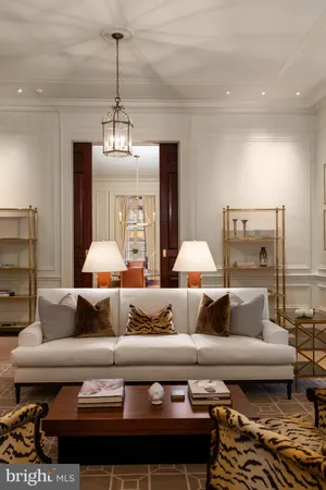 a room with lots of white walls and glass windows