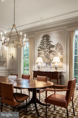 a view of a table and chairs in backyard of the house
