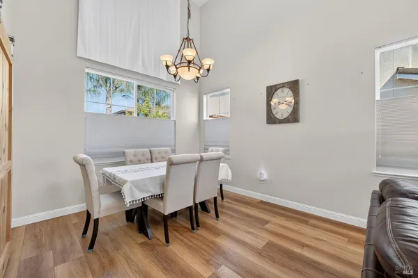 a view of a dining room with furniture wooden floor and a chandelier