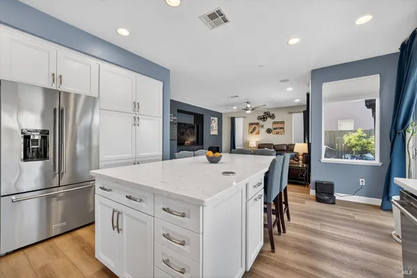 a kitchen with refrigerator cabinets dining table and chairs