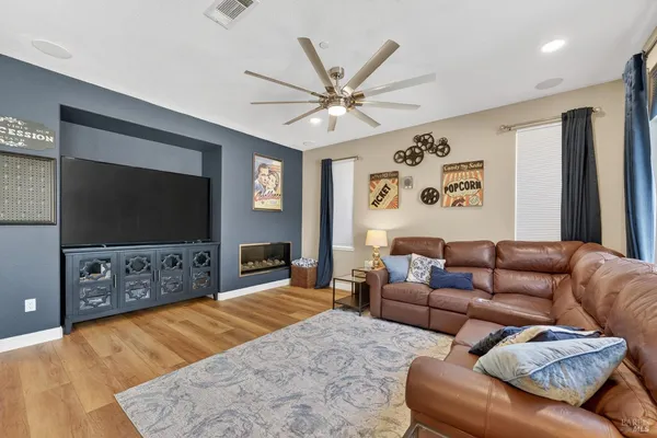 a living room with furniture and a chandelier