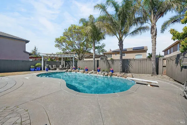 a front view of a house with a yard and palm trees