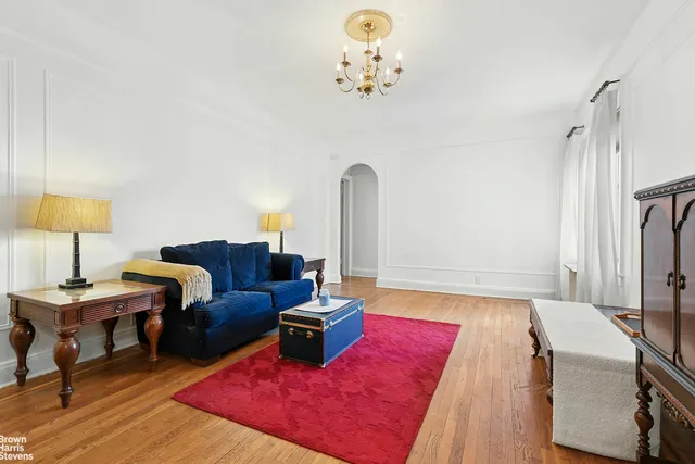 a living room with furniture rug and wooden floor