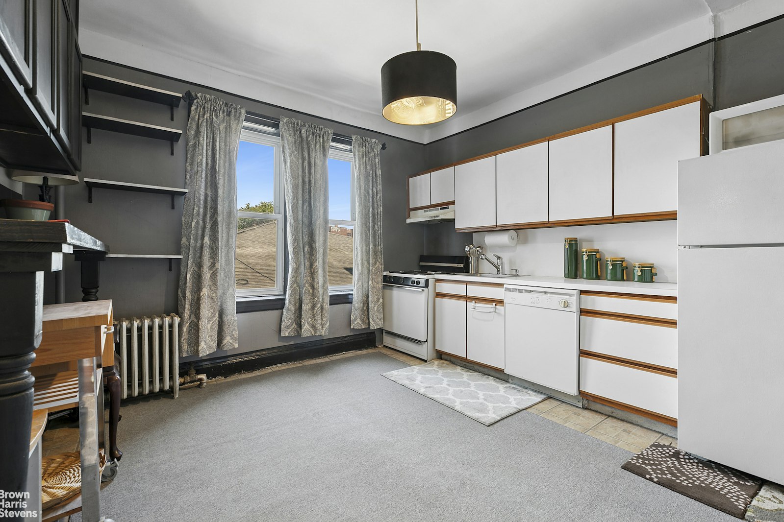 45-14 43rd Street, Unit 2D Queens, NY 11104 - Photo 2 of 6 a kitchen with white cabinets and white appliances