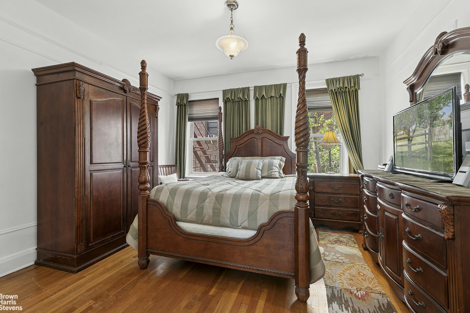 45-14 43rd Street, Unit 2D Queens, NY 11104 - Photo 4 of 6 a bedroom with a bed window and flat screen tv