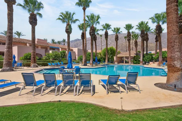 a view of a yard with a patio and swimming pool