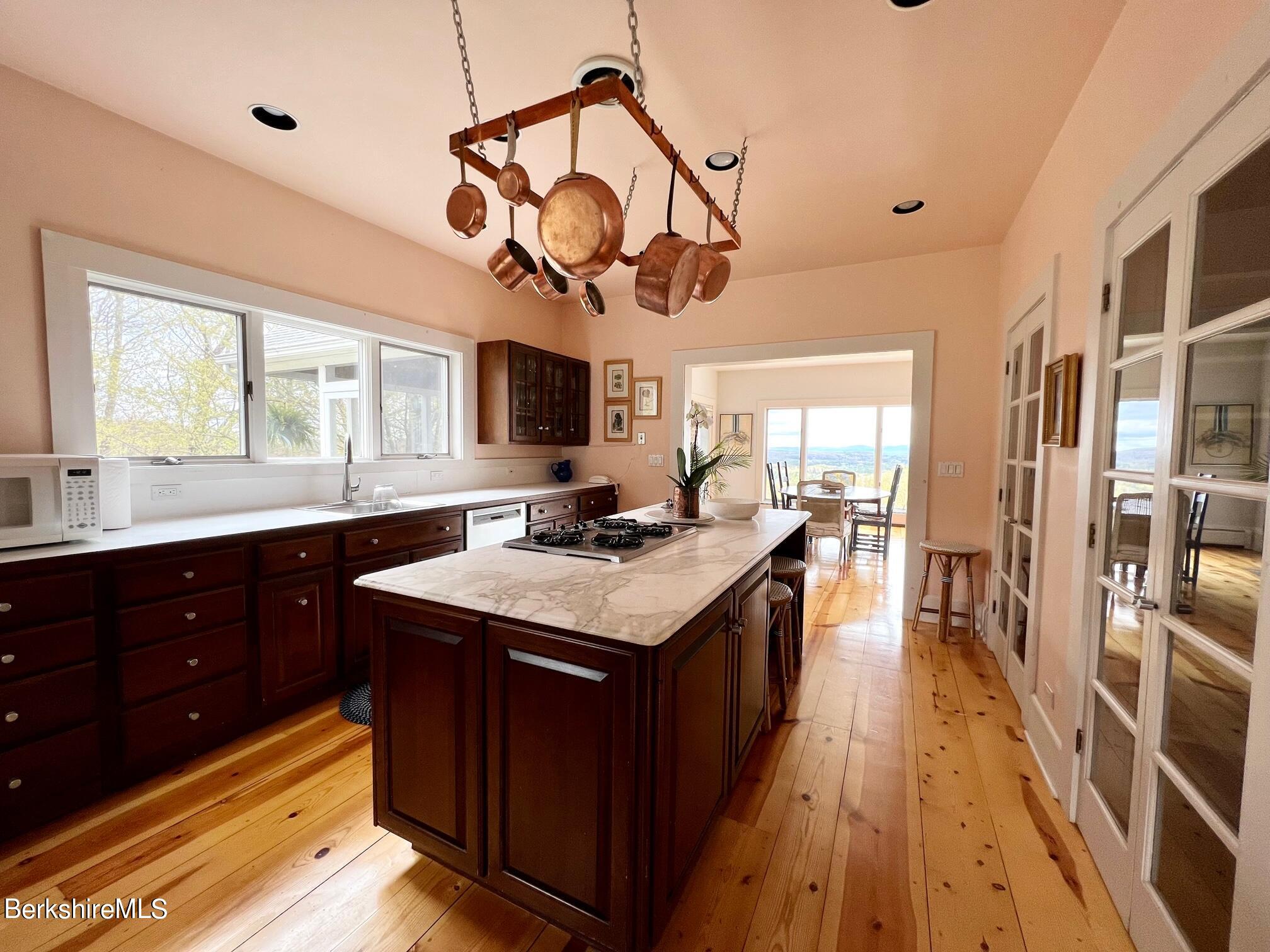 169 Mt Hunger Road Monterey, MA 01245 - Photo 22 of 51 a kitchen with a stove cabinets and wooden floor