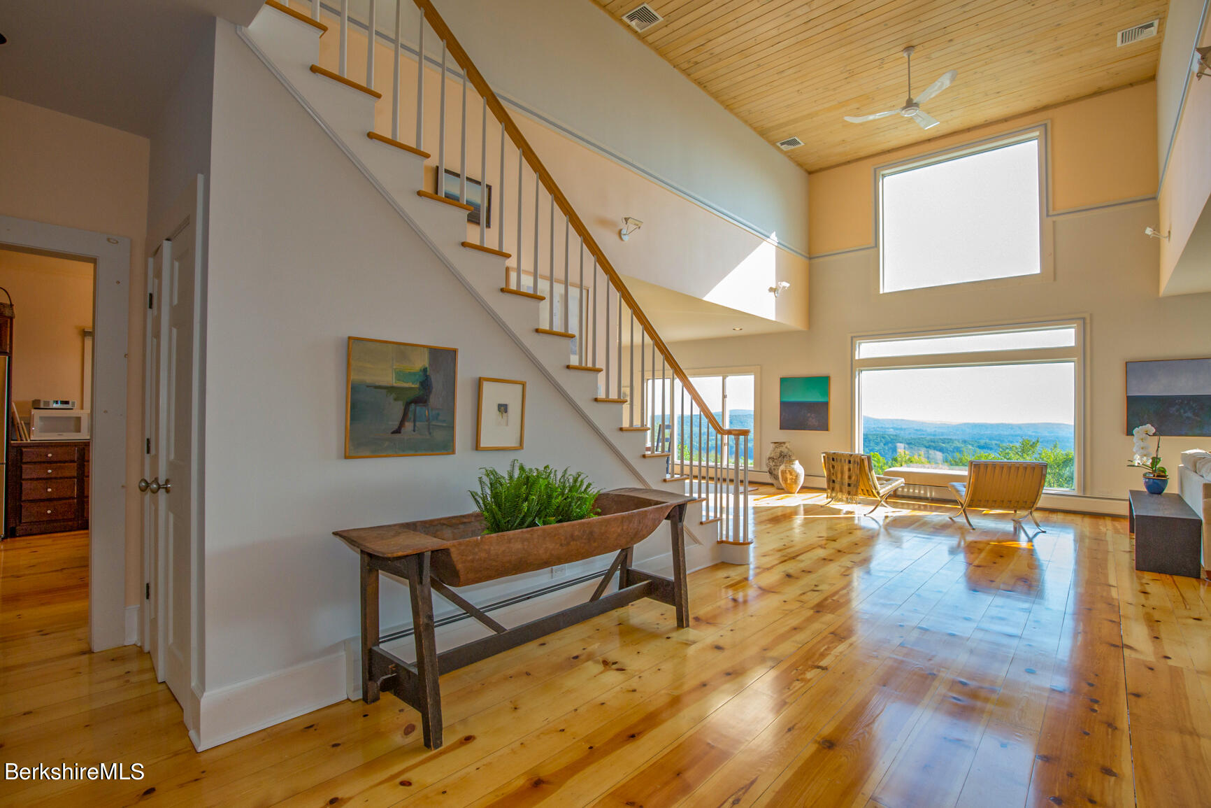 169 Mt Hunger Road Monterey, MA 01245 - Photo 8 of 51 a view of a livingroom with furniture staircase and a kitchen