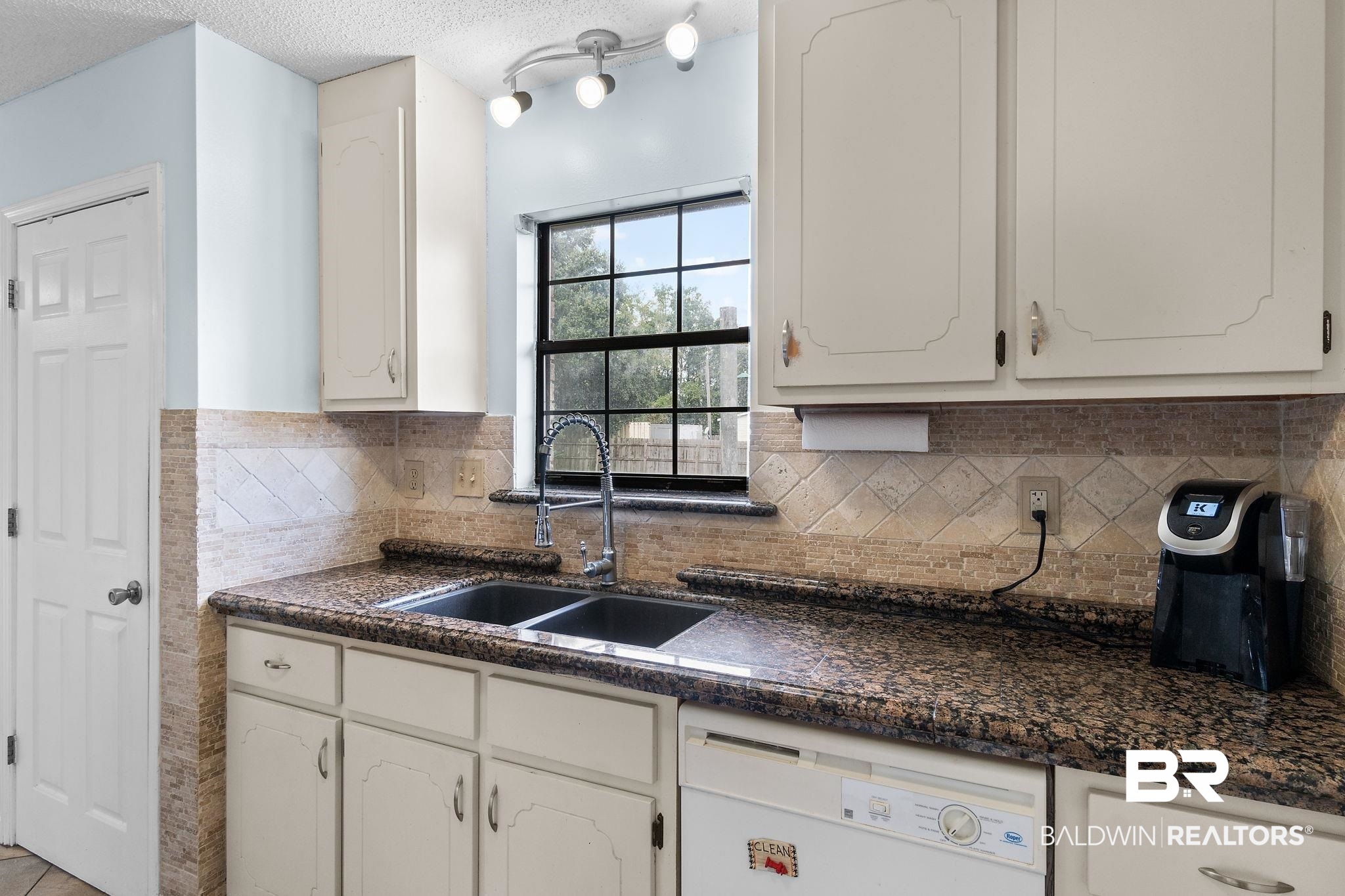 33135 Collier Road Lillian, AL 36549 - Photo 11 of 30 Kitchen with white dishwasher, decorative backsplash, a textured ceiling, white cabinetry, and dark stone counters