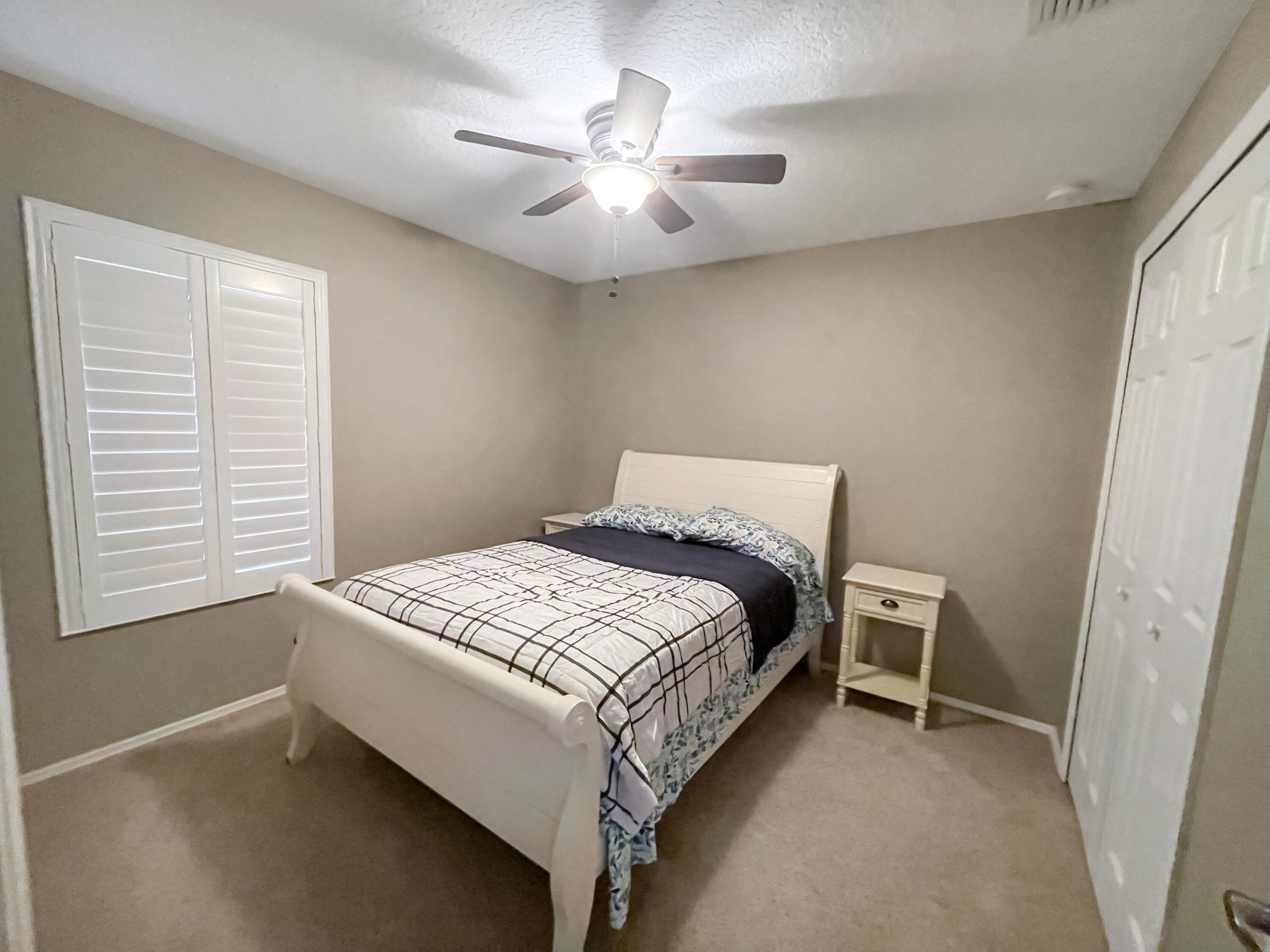 1641 Strathmore Circle Mount Dora, FL 32757 - Photo 11 of 21 a bedroom with a bed and a ceiling fan