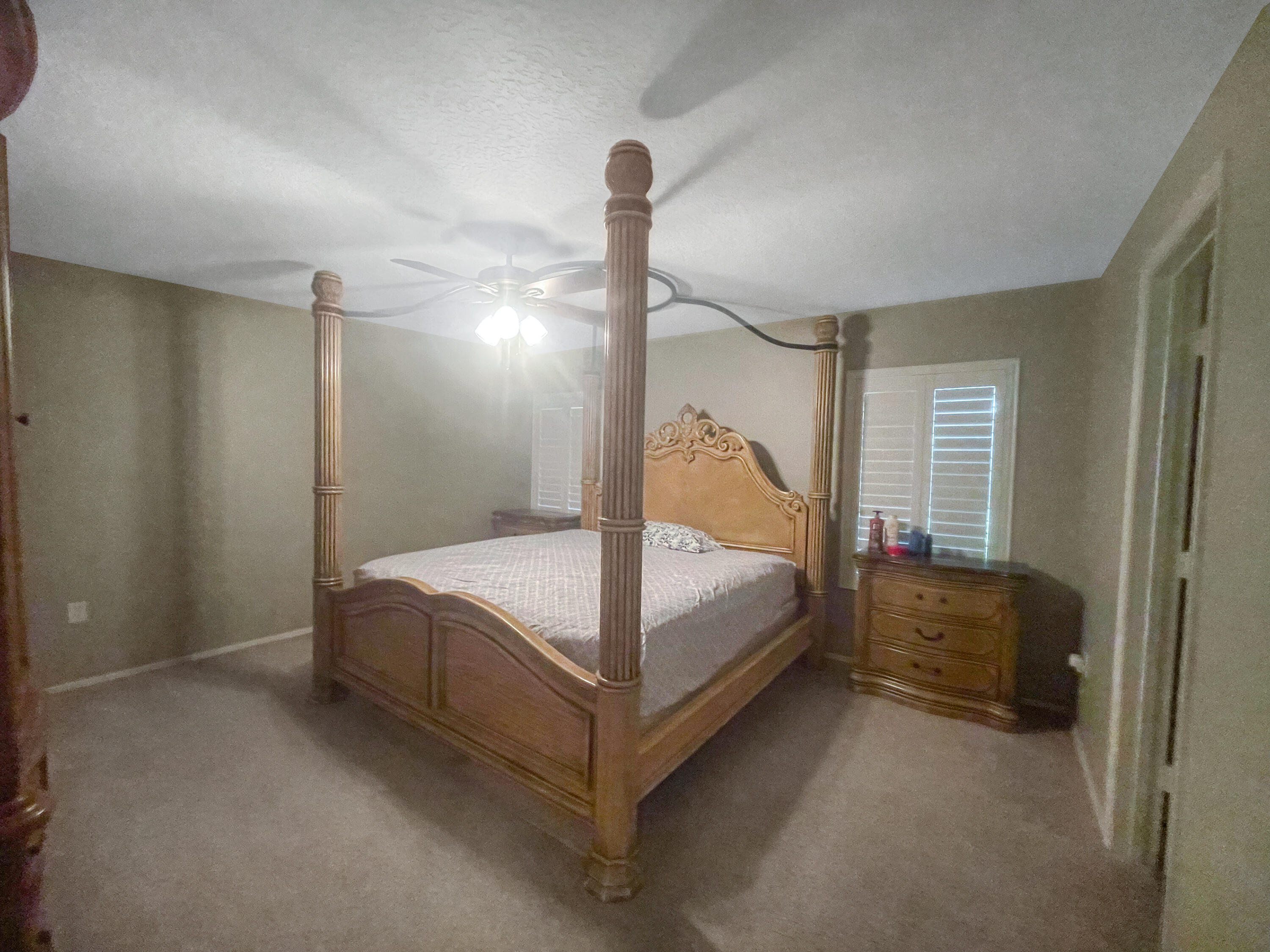 1641 Strathmore Circle Mount Dora, FL 32757 - Photo 14 of 21 a bedroom with a bed and a chandelier