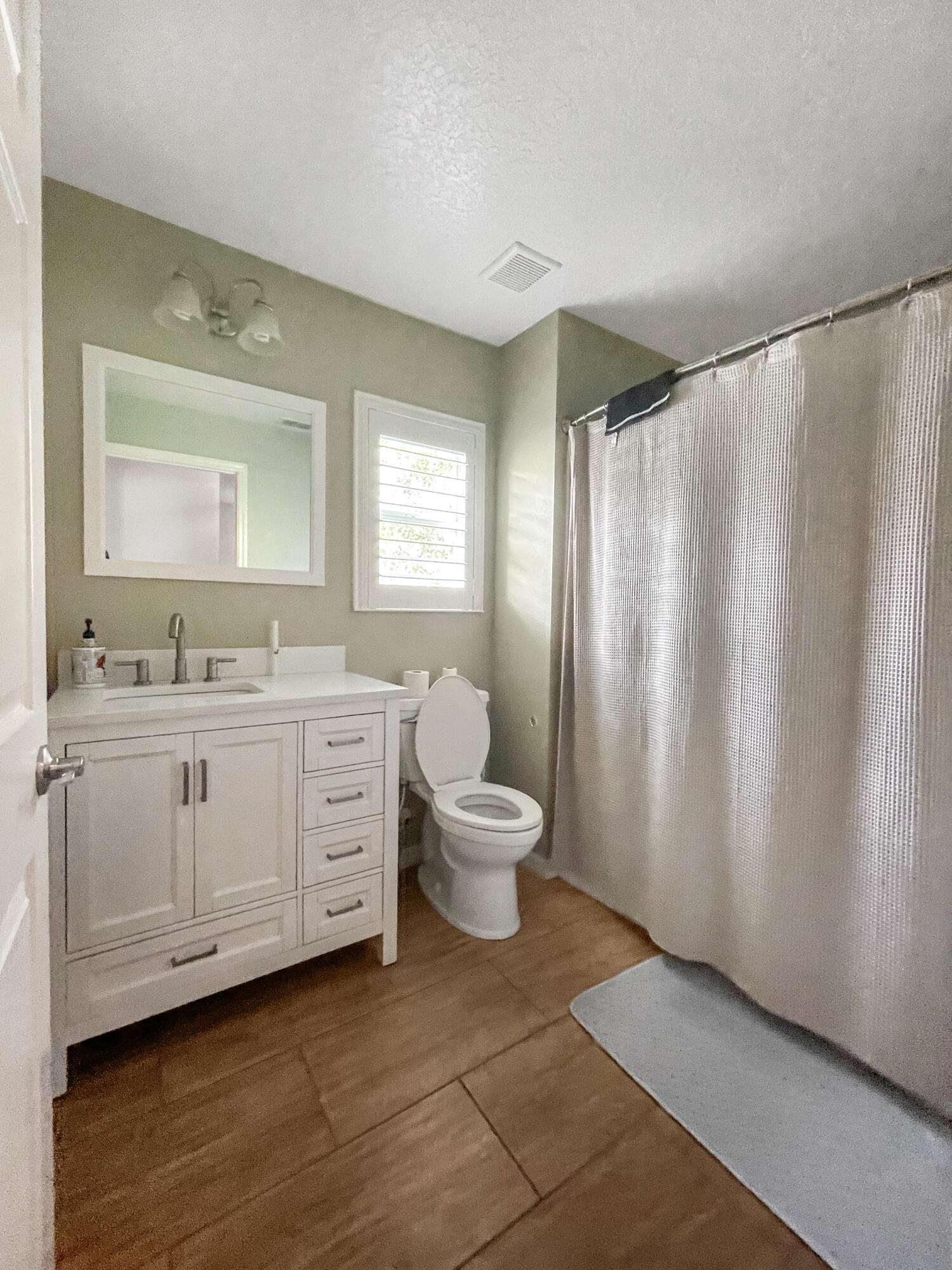 1641 Strathmore Circle Mount Dora, FL 32757 - Photo 15 of 21 a bathroom with a double vanity sink toilet mirror and window