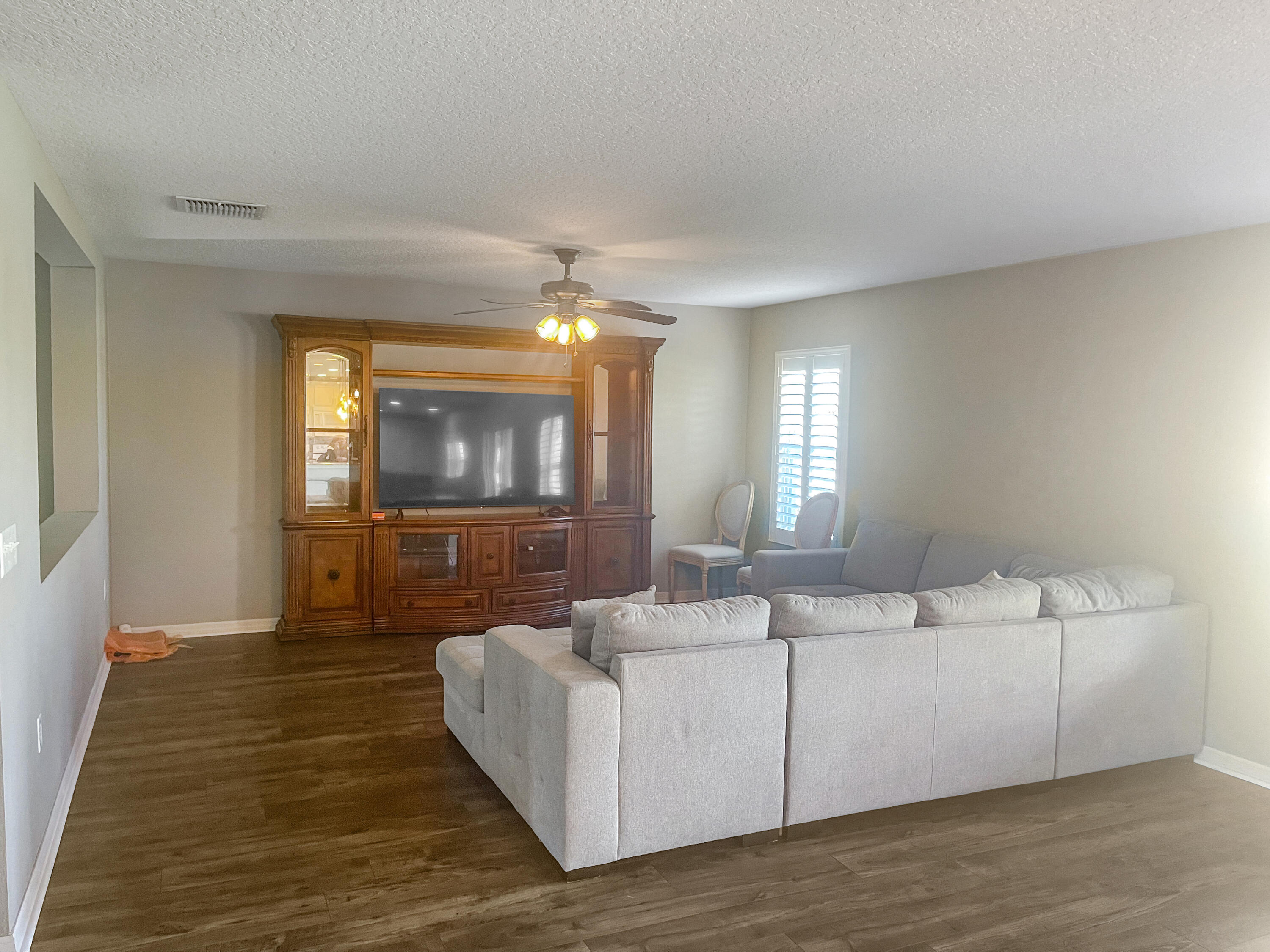 1641 Strathmore Circle Mount Dora, FL 32757 - Photo 4 of 21 a living room with furniture and a flat screen tv