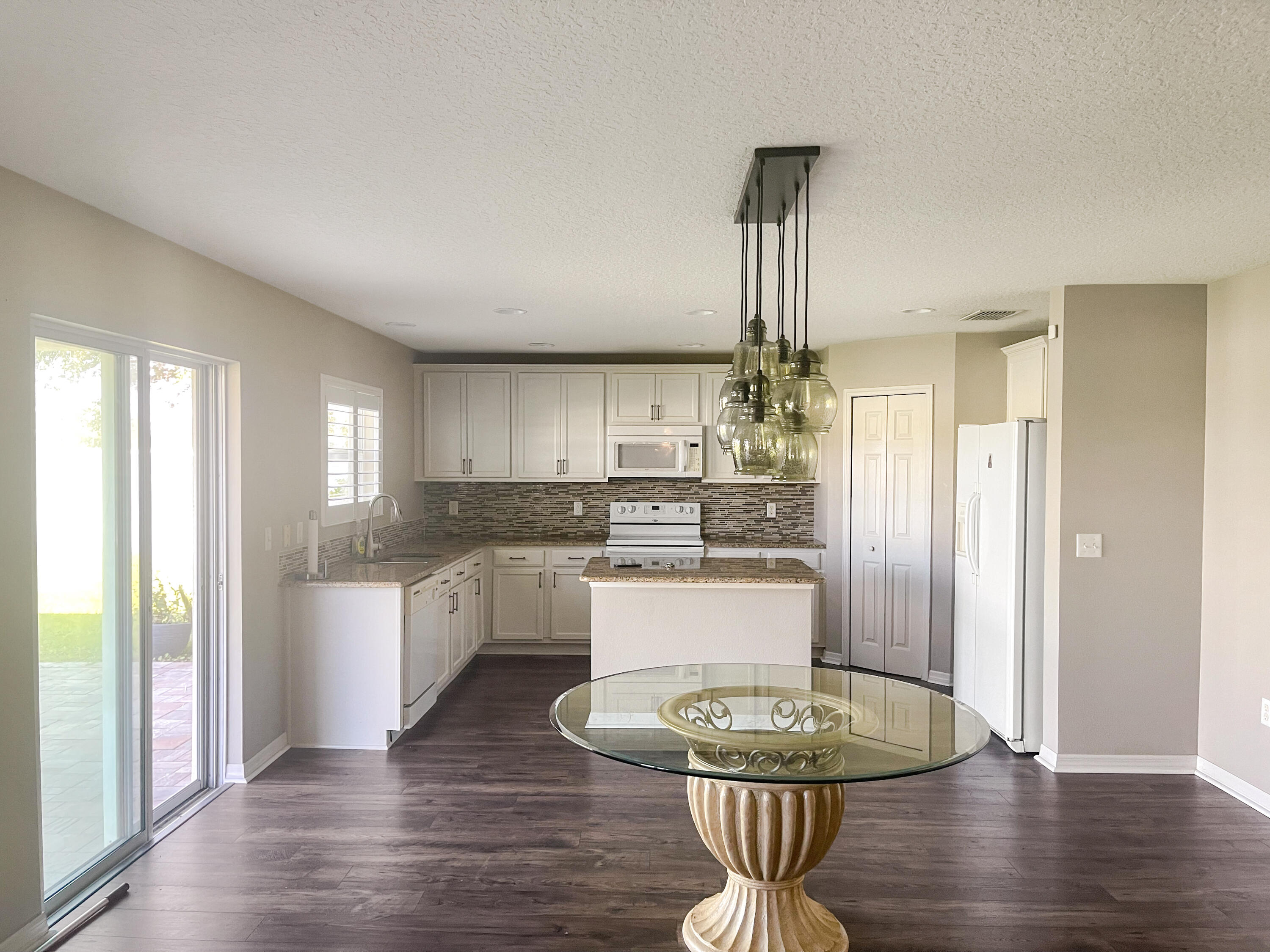1641 Strathmore Circle Mount Dora, FL 32757 - Photo 8 of 21 a kitchen with a white cabinets and appliances