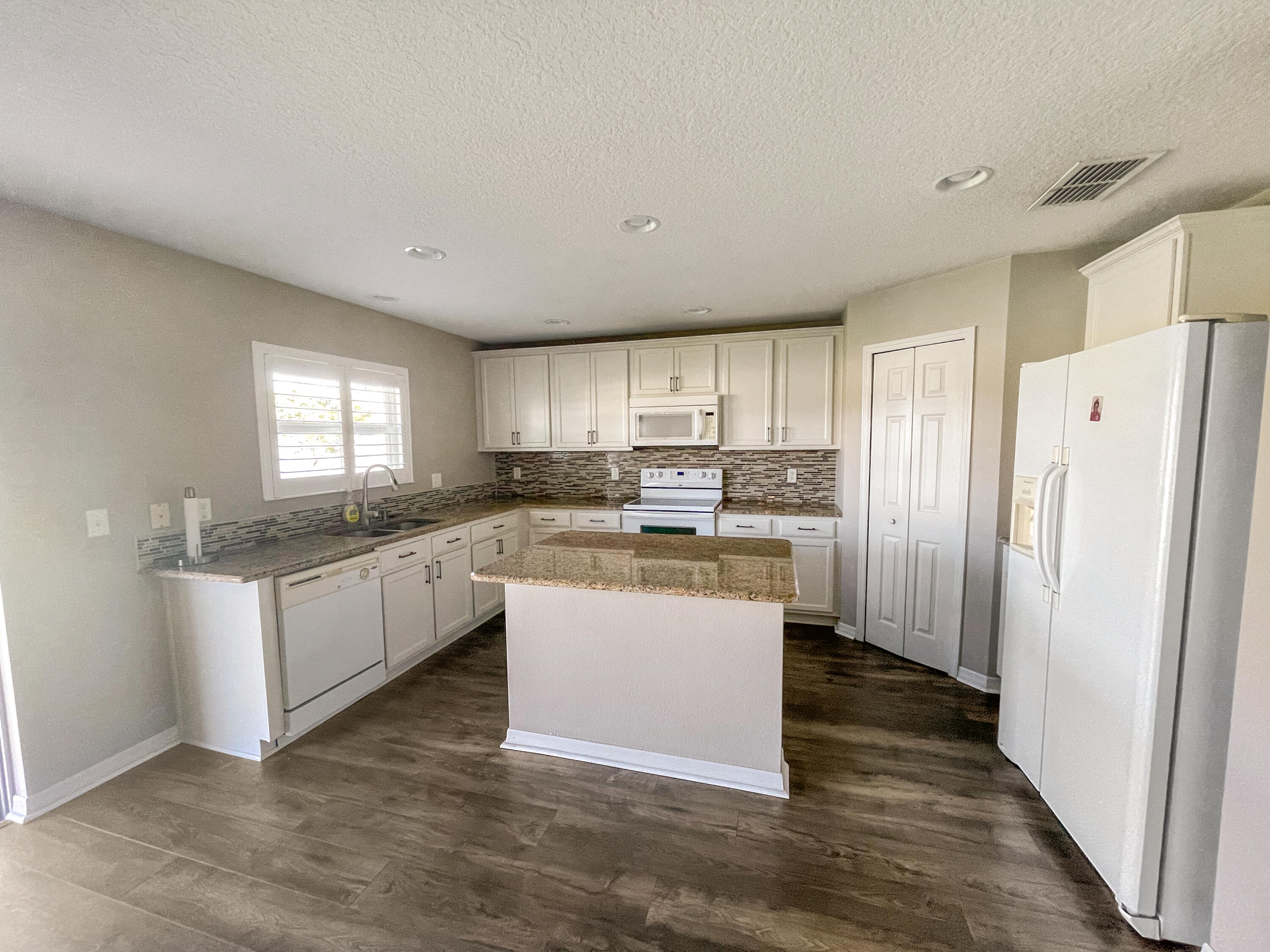 1641 Strathmore Circle Mount Dora, FL 32757 - Photo 9 of 21 a kitchen with a refrigerator a sink and cabinets