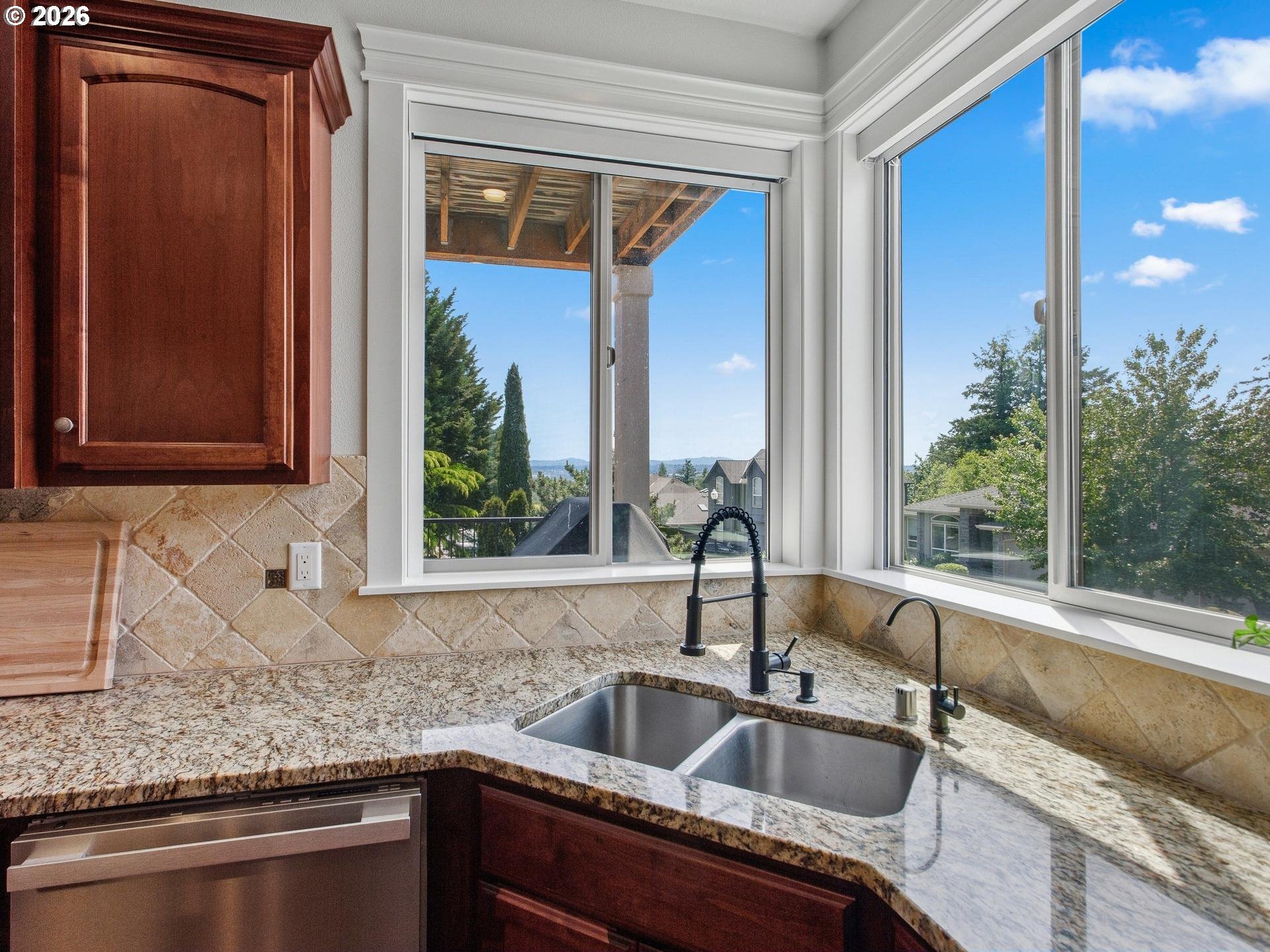 1012 Northwest Goodwin Street Camas, WA 98607 - Photo 11 of 44 a kitchen with granite countertop a sink and a window