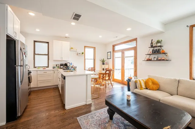a living room with furniture and a kitchen