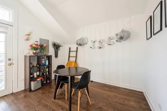 a view of a room with furniture and wooden floor