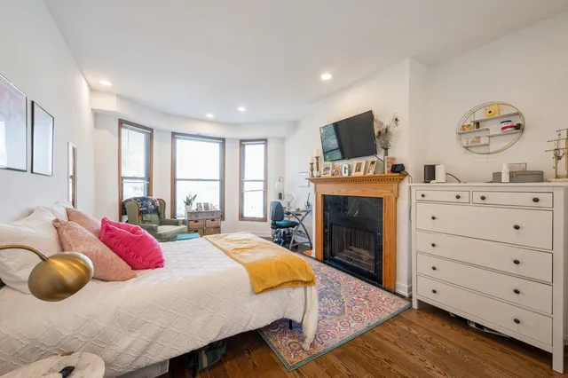 a bedroom with a bed and a fireplace