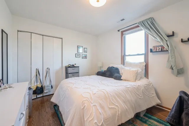 a bedroom with a bed and a window