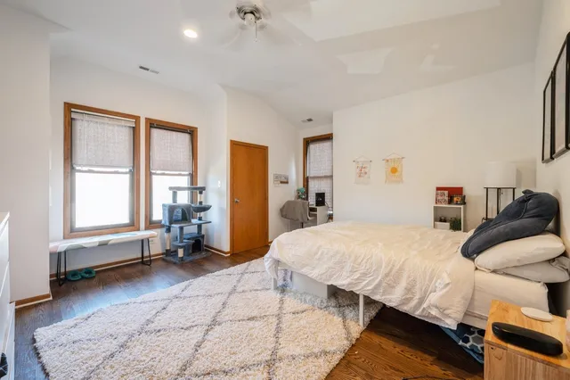 a bed room with a bed and a chair