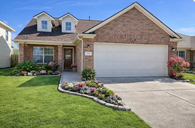 a front view of a house with a garden