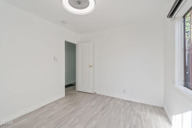 a view of a room with wooden floor and window