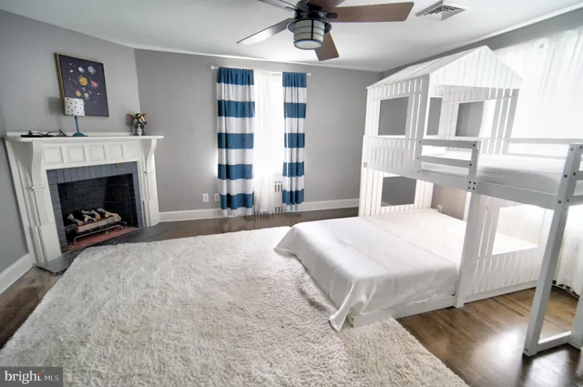 a bedroom with a bed and a fireplace