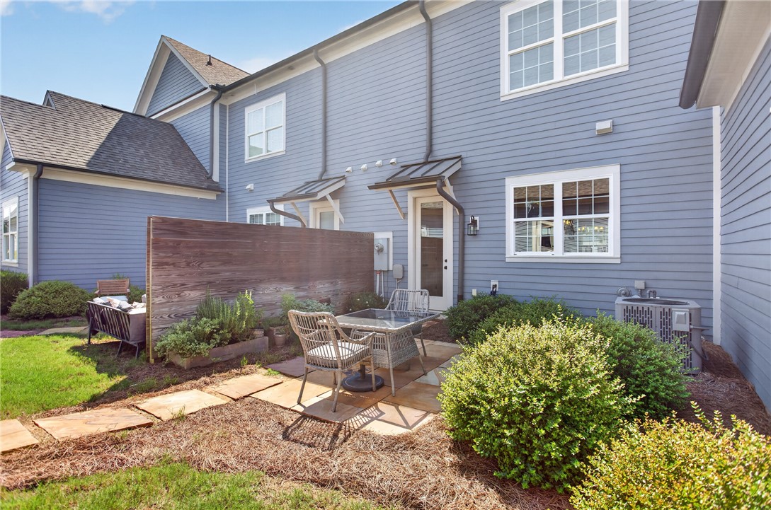 112 Tuttle Street Clemson, SC 29631 - Photo 3 of 46 A quaint patio space offers tranquil outdoor relaxation, surrounded by neat landscaping.