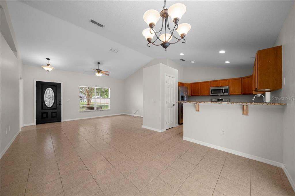 234 Locust Lane Ocala, FL 34472 - Photo 45 of 71 a view of a kitchen with a sink and chandelier