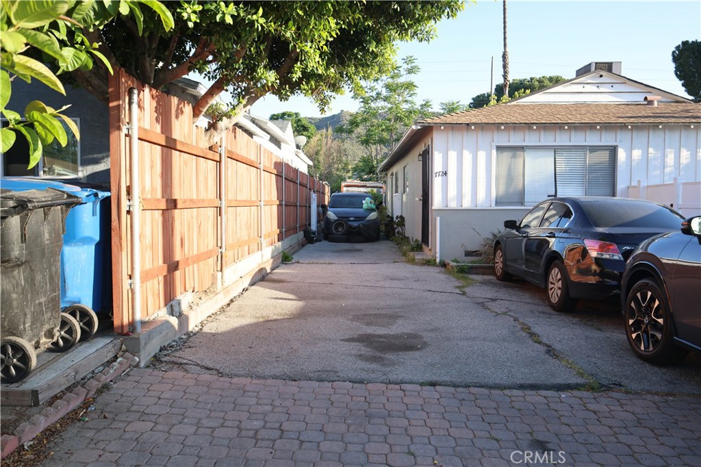 7724 Yates Street Tujunga, CA 91042 - Photo 4 of 4 a view of a house with large trees and wooden fence