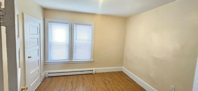a view of small space with wooden floor and closet