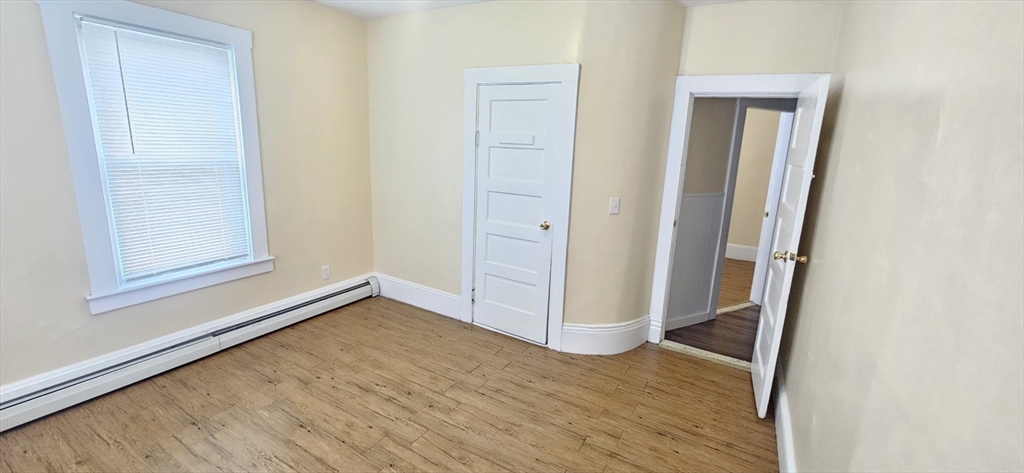 93 Arthur Street, Unit 3E Brockton, MA 02302 - Photo 5 of 8 an empty room with wooden floor and closet