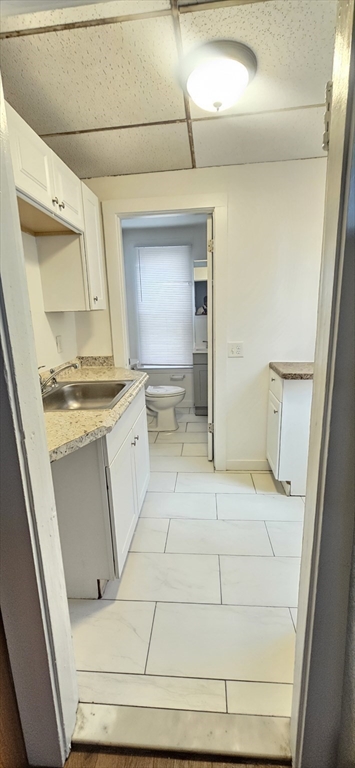 93 Arthur Street, Unit 3E Brockton, MA 02302 - Photo 6 of 8 a bathroom with a sink a toilet and a mirror