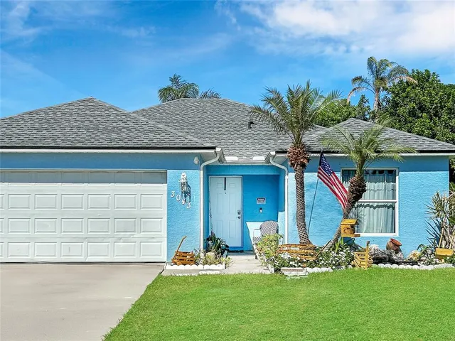 a front view of a house with a garden and plants