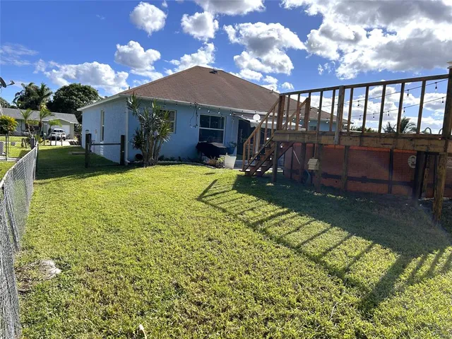 a view of a house with backyard porch and sitting area