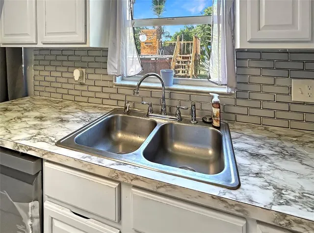 a kitchen with granite countertop a sink and a window