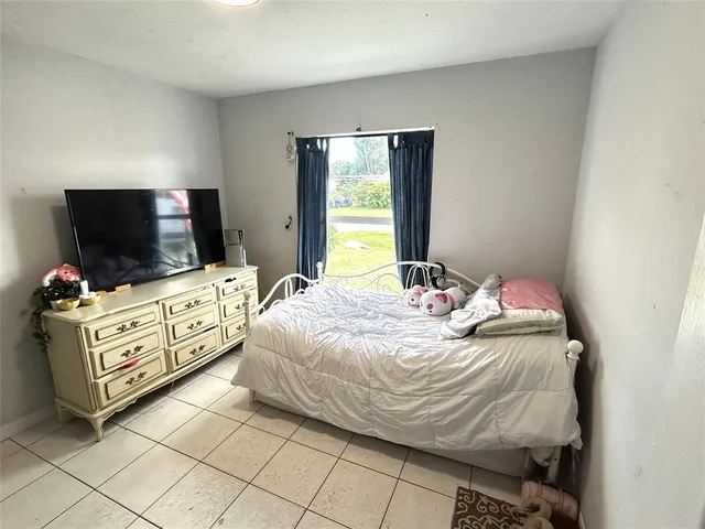 a bedroom with a bed and flat screen tv