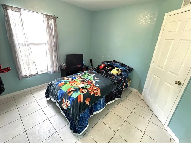 a bedroom with a bed and window