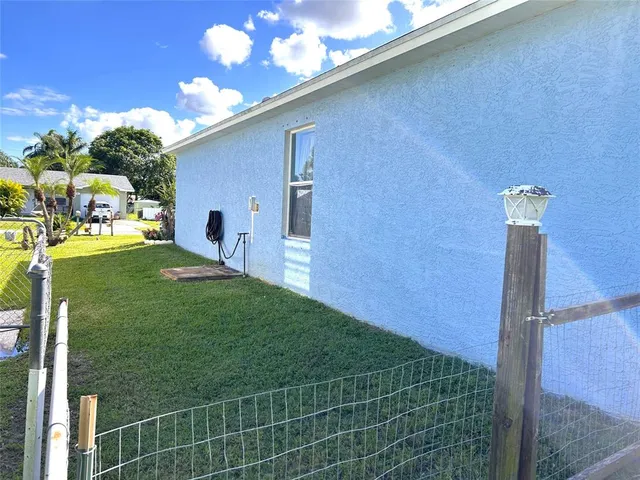 a backyard of a house with table and chairs