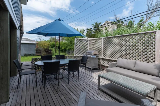 an outdoor sitting area with furniture and wooden deck