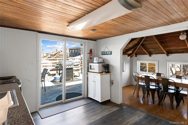 a view of a kitchen with furniture and wooden floor