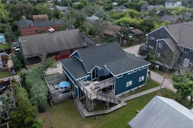 an aerial view of a house with swimming pool and a yard