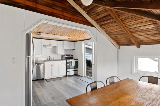 a kitchen with stainless steel appliances granite countertop a sink a stove and cabinets