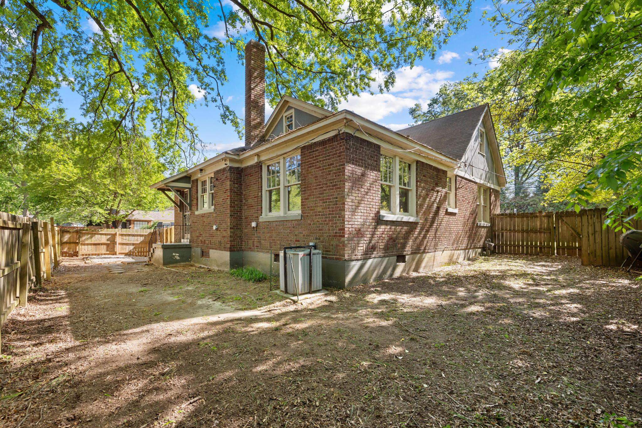 99 South Fenwick Road Memphis, TN 38111 - Photo 24 of 25 a front view of a house with a yard and large trees