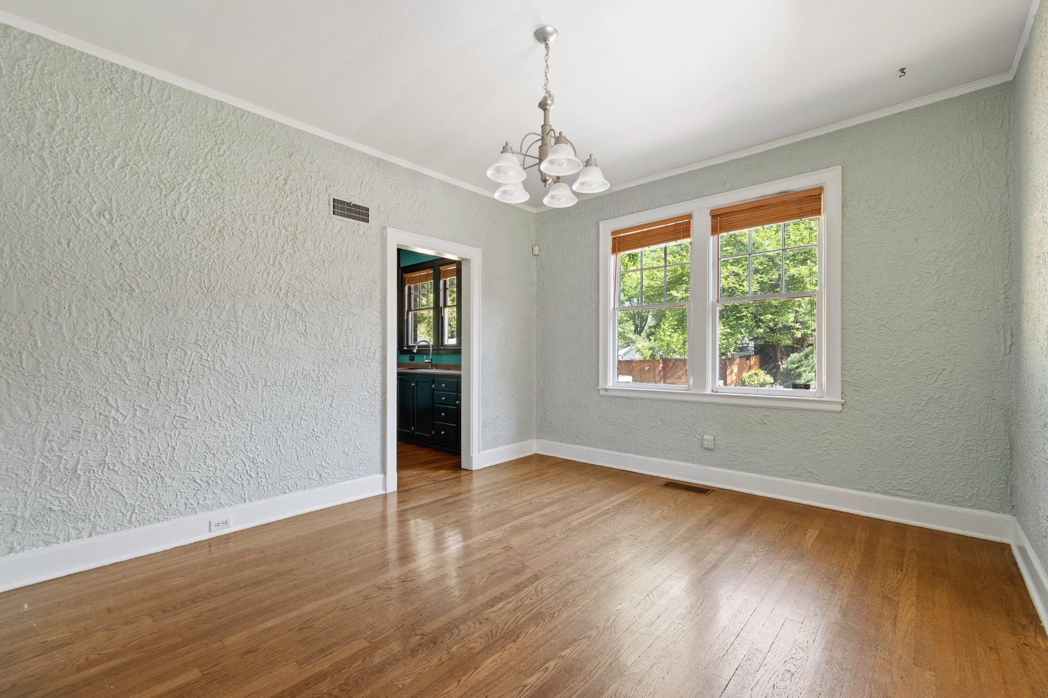 99 South Fenwick Road Memphis, TN 38111 - Photo 8 of 25 an empty room with wooden floor chandelier and windows